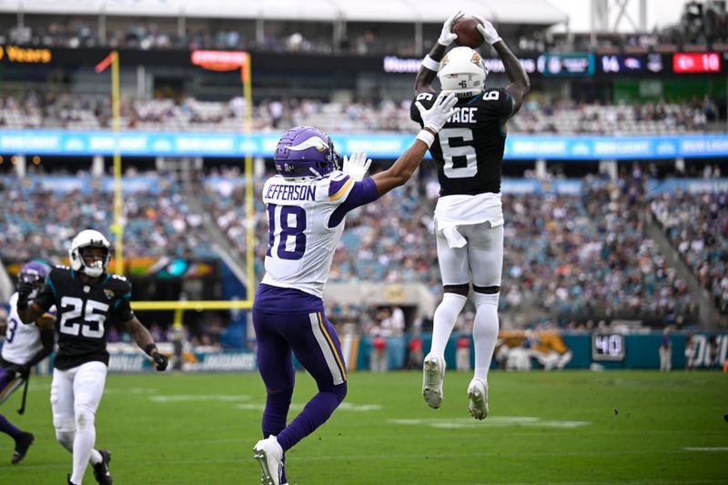 Jacksonville Jaguars safety Darnell Savage (6) intercepts a pass intended for Minnesota Vikings wide receiver Justin Jefferson (18) during the second half of an NFL football game, Sunday, Nov. 10, 2024, in Jacksonville, Fla. (AP Photo/Phelan M. Ebenhack)