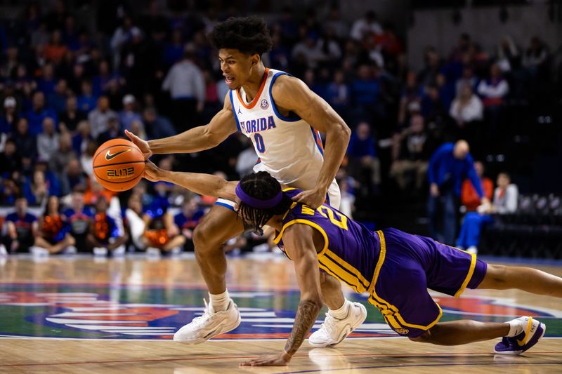 Feb 13, 2024; Gainesville, Florida, USA; LSU Tigers guard Mike Williams III (2) reaches for the ball from Florida Gators guard Zyon Pullin (0) during the second half at Exactech Arena at the Stephen C. O'Connell Center. Mandatory Credit: Matt Pendleton-USA TODAY Sports