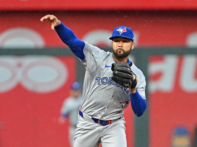 Apr 25, 2024; Kansas City, Missouri, USA;  Toronto Blue Jays second baseman Isiah Kiner-Falefa (7) throws the ball to first base to complete a double play in the third inning against the Kansas City Royals at Kauffman Stadium. Mandatory Credit: Peter Aiken-USA TODAY Sports