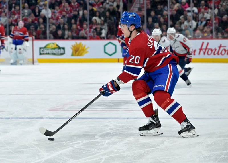 Feb 17, 2024; Montreal, Quebec, CAN; Montreal Canadiens forward Juraj Slafkovsky (20) plays the puck against the Washington Capitals during the second period at the Bell Centre. Mandatory Credit: Eric Bolte-USA TODAY Sports