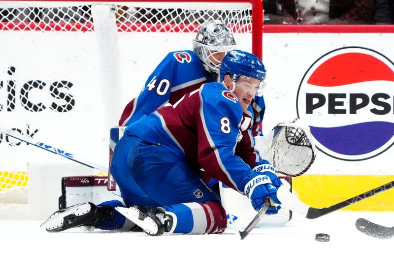 2Dec 11, 2023; Denver, Colorado, USA; Colorado Avalanche defenseman Cale Makar (8) and Colorado Avalanche goaltender Alexandar Georgiev (40) reach for the puck in the second period against the Calgary Flames at Ball Arena. Mandatory Credit: Ron Chenoy-USA TODAY Sports