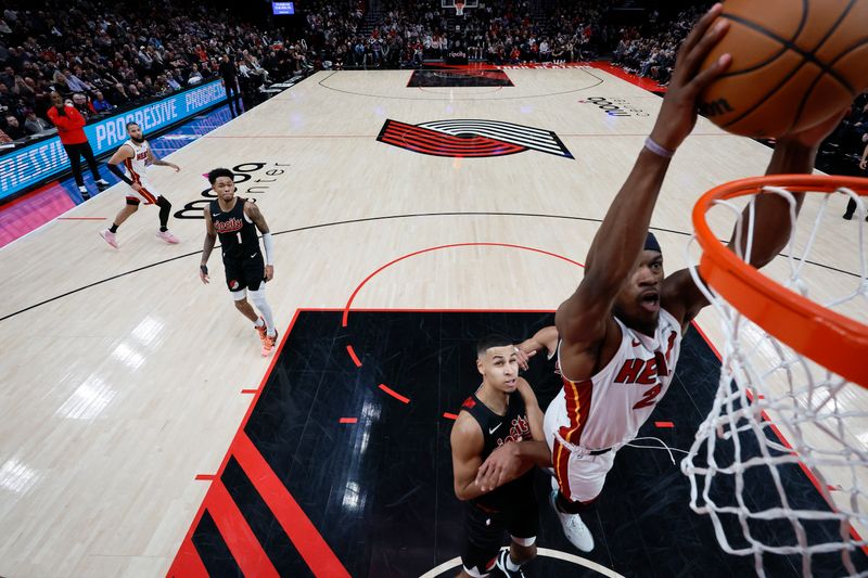 PORTLAND, OREGON - FEBRUARY 27: Jimmy Butler #22 of the Miami Heat dunks the ball past Kris Murray #8 of the Portland Trail Blazers during the second half at Moda Center on February 27, 2024 in Portland, Oregon. NOTE TO USER: User expressly acknowledges and agrees that, by downloading and or using this photograph, User is consenting to the terms and conditions of the Getty Images License Agreement. (Photo by Soobum Im/Getty Images)