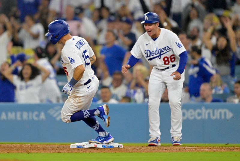 Aug 17, 2023; Los Angeles, California, USA;  Los Angeles Dodgers catcher Austin Barnes (15) is greeted by first base coach Clayton McCullough (86) after hitting a solo home run in the eighth inning against the Milwaukee Brewers at Dodger Stadium. Mandatory Credit: Jayne Kamin-Oncea-USA TODAY Sports