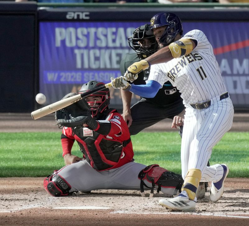 Sep 28, 2025; Milwaukee, Wisconsin, USA; Milwaukee Brewers outfielder Jackson Chourio (11) hits a double during the third inning of their game against the Cincinnati Reds at American Family Field. Mandatory Credit: Mark Hoffman-USA TODAY Network via Imagn Images