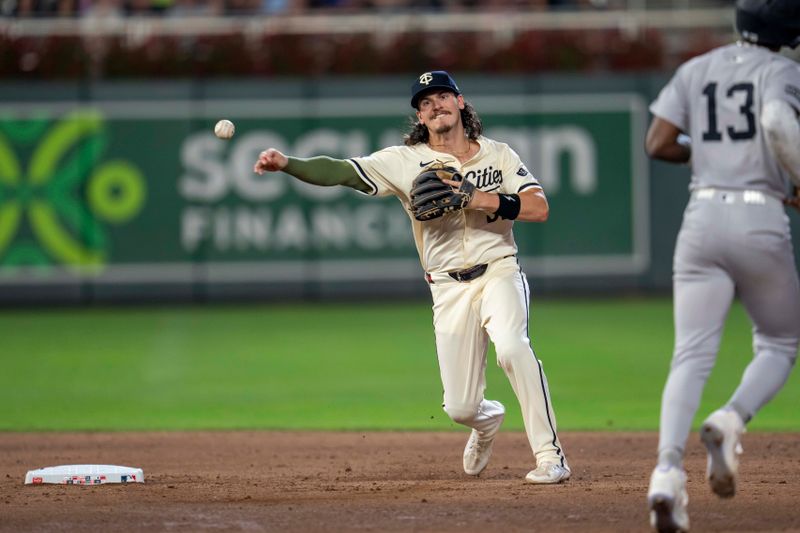 Sep 16, 2025; Minneapolis, Minnesota, USA; Minnesota Twins shortstop Ryan Fitzgerald (53) forces out New York Yankees second baseman Jazz Chisholm Jr. (13) at second base and throws the ball to first base for a double play in the sixth inning at Target Field. Mandatory Credit: Jesse Johnson-Imagn Images
