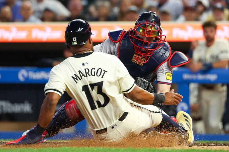 Aug 28, 2024; Minneapolis, Minnesota, USA; Atlanta Braves catcher Sean Murphy (12) tags out Minnesota Twins left fielder Manuel Margot (13) at home plate during the sixth inning at Target Field. Mandatory Credit: Matt Krohn-USA TODAY Sports