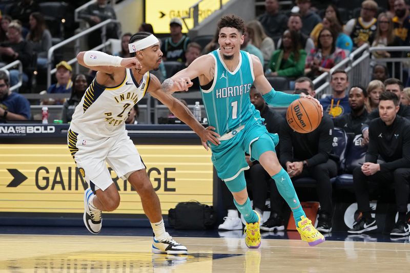 INDIANAPOLIS, INDIANA - OCTOBER 17: LaMelo Ball #1 of the Charlotte Hornets dribbles the ball while being guarded by Andrew Nembhard #2 of the Indiana Pacers in the first quarter during a preseason game at Gainbridge Fieldhouse on October 17, 2024 in Indianapolis, Indiana. NOTE TO USER: User expressly acknowledges and agrees that, by downloading and or using this photograph, User is consenting to the terms and conditions of the Getty Images License Agreement. (Photo by Dylan Buell/Getty Images)