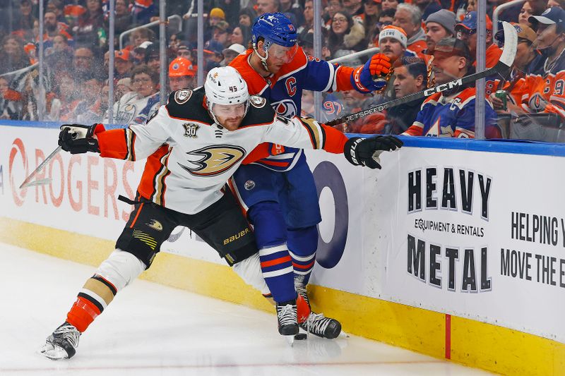 Nov 26, 2023; Edmonton, Alberta, CAN; Anaheim Ducks forward Max Jones (49) and Edmonton Oilers forward Connor McDavid (97) battle along the boards for a loose puck during the first period at Rogers Place. Mandatory Credit: Perry Nelson-USA TODAY Sports