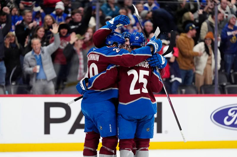 Jan 14, 2025; Denver, Colorado, USA; Colorado Avalanche defenseman Devon Toews (7) (center) celebrates his overtime goal with center Nathan MacKinnon (29) and right wing Logan O'Connor (25) a overtime win against the New York Rangers at Ball Arena. Mandatory Credit: Ron Chenoy-Imagn Images