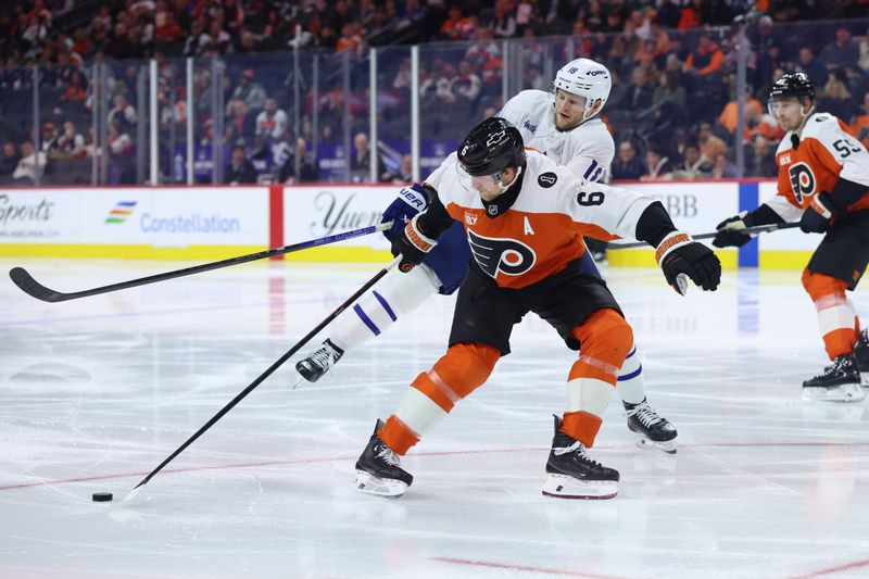 Jan 8, 2026; Philadelphia, Pennsylvania, USA; Philadelphia Flyers defenseman Travis Sanheim (6) breaks up the rush of Toronto Maple Leafs center Steven Lorentz (18) during the second period at Xfinity Mobile Arena. Mandatory Credit: Bill Streicher-Imagn Images
