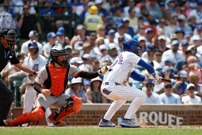 Jun 19, 2024; Chicago, Illinois, USA; Chicago Cubs outfielder Pete Crow-Armstrong (52) hits an RBI-sacrifice bunt against the San Francisco Giants during the fourth inning at Wrigley Field. Mandatory Credit: Kamil Krzaczynski-USA TODAY Sports