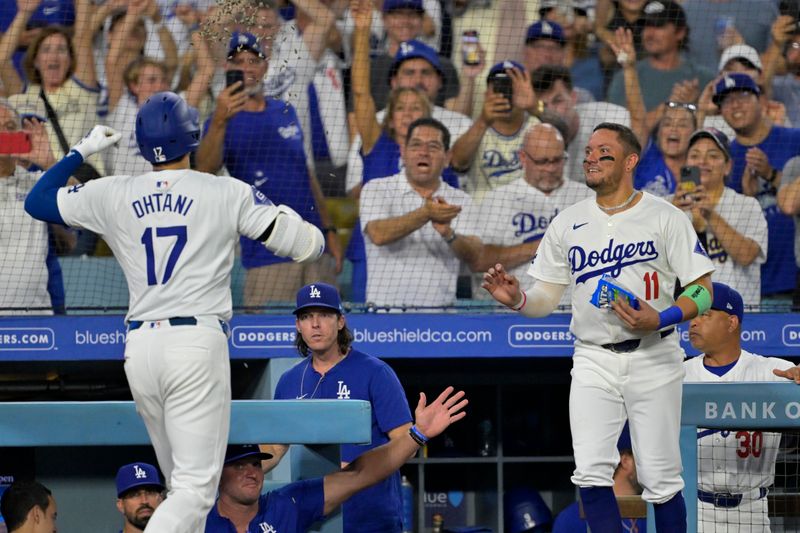 Sep 6, 2024; Los Angeles, California, USA;  Los Angeles Dodgers designated hitter Shohei Ohtani (17) is congratulated by Los Angeles Dodgers shortstop Miguel Rojas (11) after hitting his 45th home run on the season in the sixth inning against the Cleveland Guardians at Dodger Stadium. Mandatory Credit: Jayne Kamin-Oncea-Imagn Images