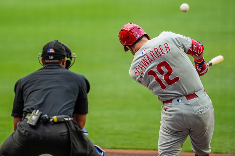 Jun 28, 2025; Cumberland, Georgia, USA; Philadelphia Phillies left fielder Kyle Schwarber (12) hits a double against the Atlanta Braves during the first inning at Truist Park. Mandatory Credit: Dale Zanine-Imagn Images