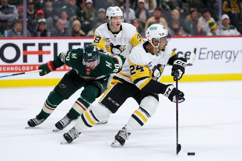 Oct 30, 2025; Saint Paul, Minnesota, USA; Pittsburgh Penguins defenseman Mathew Dumba (24) skates with the puck as Minnesota Wild left wing Marcus Johansson (90) defends during the second period at Grand Casino Arena. Mandatory Credit: Matt Krohn-Imagn Images