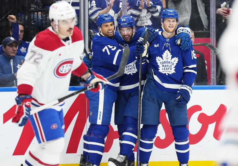 Nov 9, 2024; Toronto, Ontario, CAN; Toronto Maple Leafs defenseman Conor Timmins (25) scores a gaol and celebrates with right wing Ryan Reaves (75) against the Montreal Canadiens during the first period at Scotiabank Arena. Mandatory Credit: Nick Turchiaro-Imagn Images