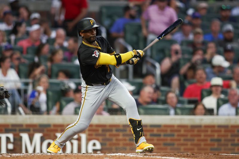 Jun 28, 2024; Atlanta, Georgia, USA; Pittsburgh Pirates outfielder Andrew McCutchen (22) hits a single against the Atlanta Braves in the sixth inning at Truist Park. Mandatory Credit: Brett Davis-USA TODAY Sports