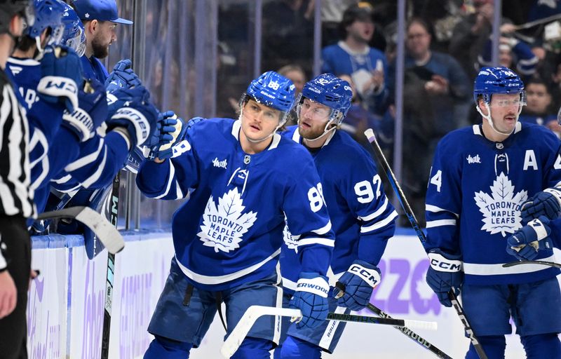 Nov 24, 2024; Toronto, Ontario, CAN;  Toronto Maple Leafs forward William Nylander (88) celebrates with teammates at the bench after scoring against the Utah Hockey Club in the second period at Scotiabank Arena. Mandatory Credit: Dan Hamilton-Imagn Images