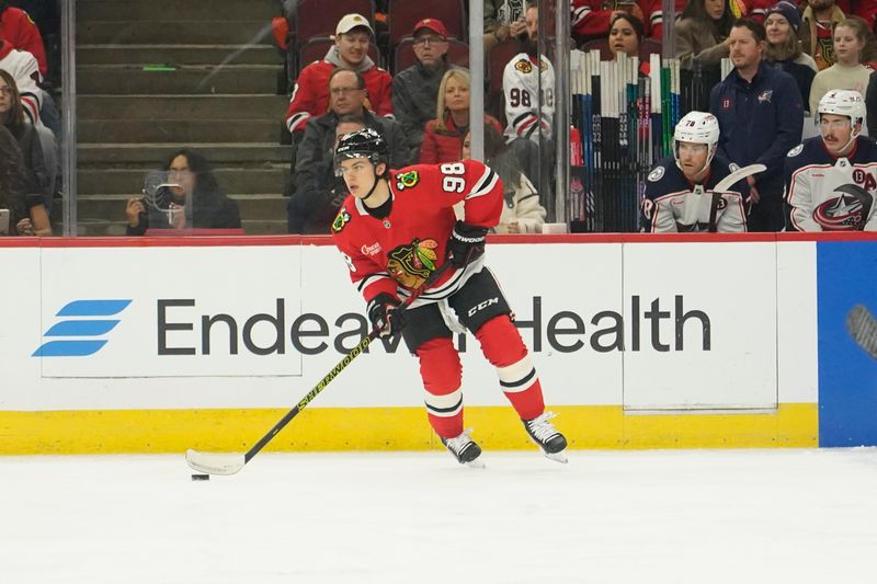 Dec 1, 2024; Chicago, Illinois, USA; Chicago Blackhawks center Connor Bedard (98) looks to pass against the Columbus Blue Jackets during the first period at United Center. Mandatory Credit: David Banks-Imagn Images