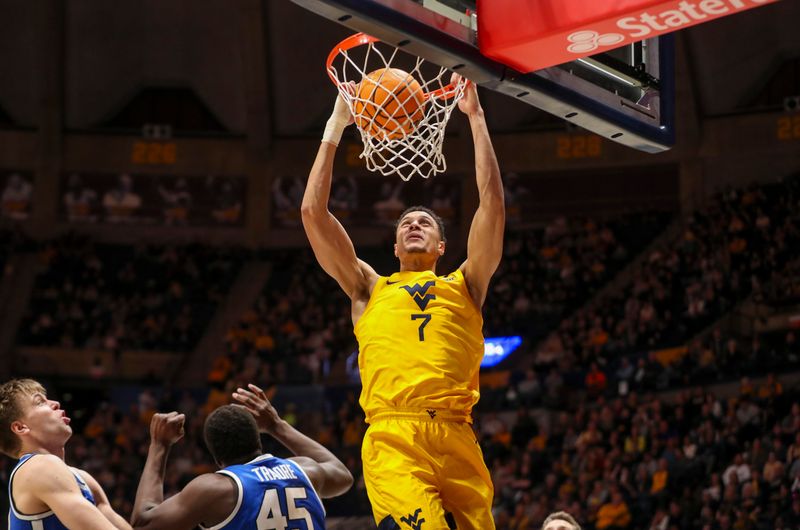 Feb 3, 2024; Morgantown, West Virginia, USA; West Virginia Mountaineers center Jesse Edwards (7) dunks the ball during the second half against the Brigham Young Cougars at WVU Coliseum. Mandatory Credit: Ben Queen-USA TODAY Sports