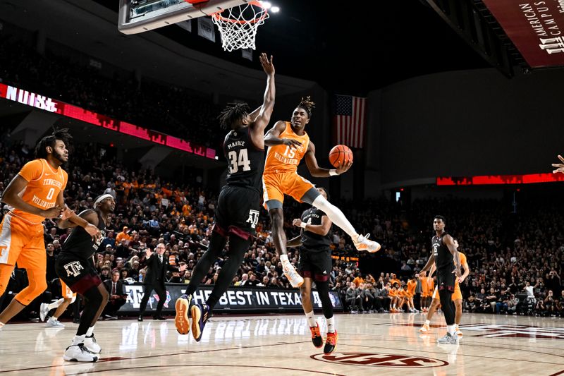 Feb 21, 2023; College Station, Texas, USA;  Tennessee Volunteers guard Jahmai Mashack (15) shoots the ball against Texas A&M Aggies forward Julius Marble (34) during the first half at Reed Arena. Mandatory Credit: Maria Lysaker-USA TODAY Sports