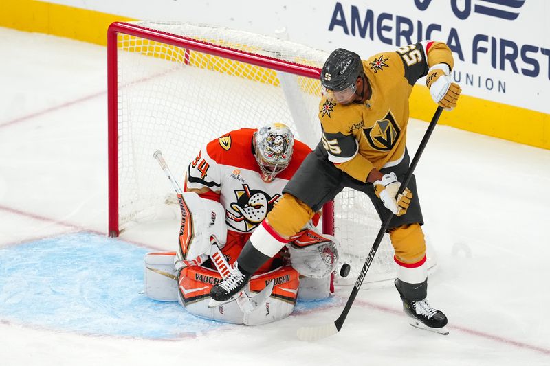 Nov 8, 2025; Las Vegas, Nevada, USA; Anaheim Ducks goaltender Petr Mrazek (34) makes a save as Vegas Golden Knights right wing Keegan Kolesar (55) attempts a deflection during the third period at T-Mobile Arena. Mandatory Credit: Stephen R. Sylvanie-Imagn Images