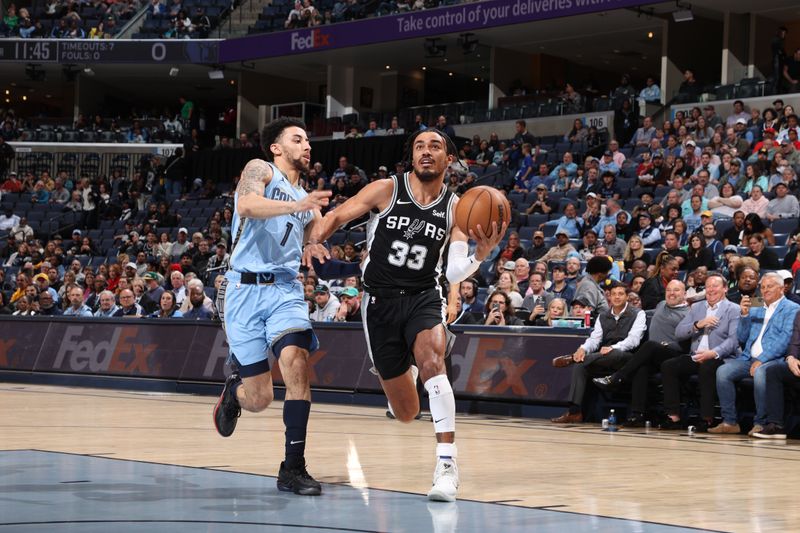 MEMPHIS, TN - APRIL 9: Tre Jones #33 of the San Antonio Spurs drives to the basket during the game against the Memphis Grizzlies on April 9, 2024 at FedExForum in Memphis, Tennessee. NOTE TO USER: User expressly acknowledges and agrees that, by downloading and or using this photograph, User is consenting to the terms and conditions of the Getty Images License Agreement. Mandatory Copyright Notice: Copyright 2024 NBAE (Photo by Joe Murphy/NBAE via Getty Images)