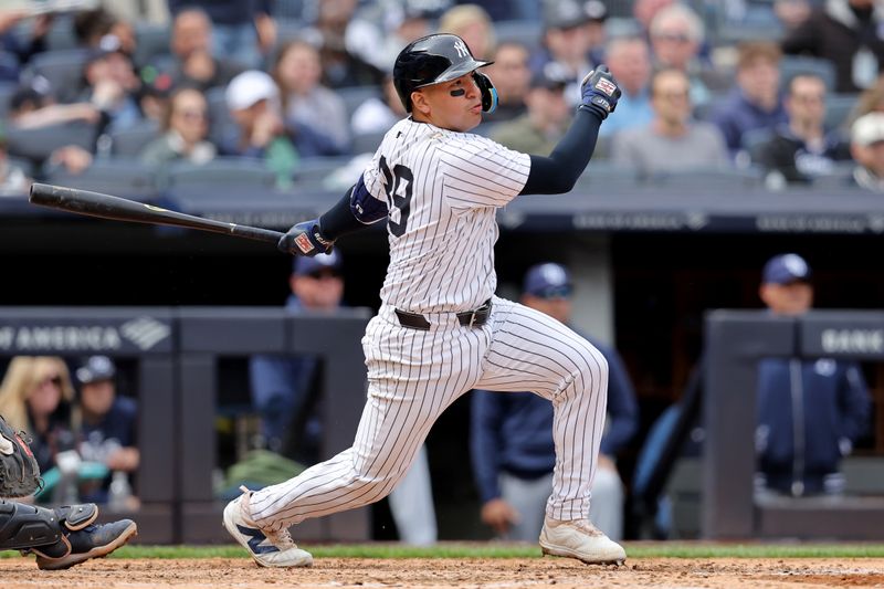 Apr 21, 2024; Bronx, New York, USA; New York Yankees catcher Jose Trevino (39) follows through on an RBI single against the Tampa Bay Rays during the fifth inning at Yankee Stadium. Mandatory Credit: Brad Penner-USA TODAY Sports