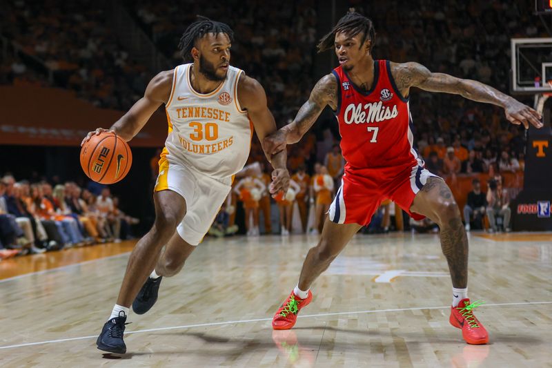 Jan 6, 2024; Knoxville, Tennessee, USA; Tennessee Volunteers guard Josiah-Jordan James (30) moves the ball against Mississippi Rebels guard Allen Flanigan (7) during the first half at Thompson-Boling Arena at Food City Center. Mandatory Credit: Randy Sartin-USA TODAY Sports