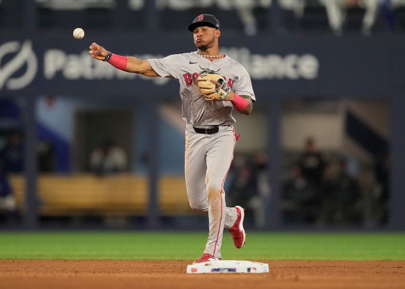 Jun 18, 2024; Toronto, Ontario, CAN; Boston Red Sox shortstop Ceddanne Rafaela (43) throws to first base to put out Toronto Blue Jays first baseman Vladimir Guerrero Jr. (not pictured) at first base during the seventh inning at Rogers Centre. Mandatory Credit: John E. Sokolowski-USA TODAY Sports