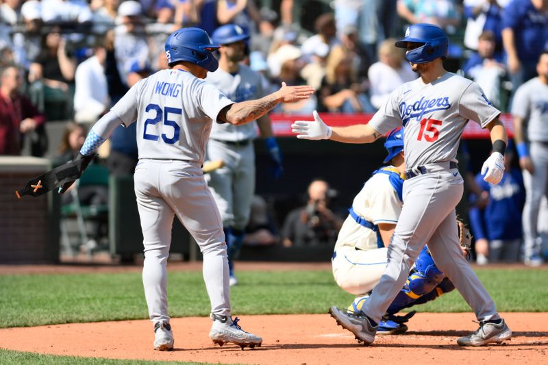 Sep 17, 2023; Seattle, Washington, USA; Los Angeles Dodgers second baseman Kolten Wong (25) and catcher Austin Barnes (15) celebrate after Barnes hit a 2-run home run against the Seattle Mariners during the second inning at T-Mobile Park. Mandatory Credit: Steven Bisig-USA TODAY Sports