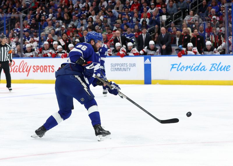 Jan 27, 2024; Tampa, Florida, USA; Tampa Bay Lightning right wing Nikita Kucherov (86) shoots against the New Jersey Devils during the third period at Amalie Arena. Mandatory Credit: Kim Klement Neitzel-USA TODAY Sports