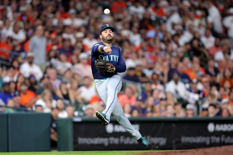Sep 19, 2025; Houston, Texas, USA; Seattle Mariners third baseman Eugenio Suarez (28) throws a fielded ball to first base for an out against the Houston Astros during the third inning at Daikin Park. Mandatory Credit: Erik Williams-Imagn Images