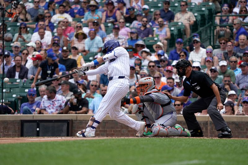 Jun 22, 2024; Chicago, Illinois, USA; Chicago Cubs outfielder Seiya Suzuki (27) hits an RBI single against the New York Mets during the first inning at Wrigley Field. Mandatory Credit: David Banks-USA TODAY Sports