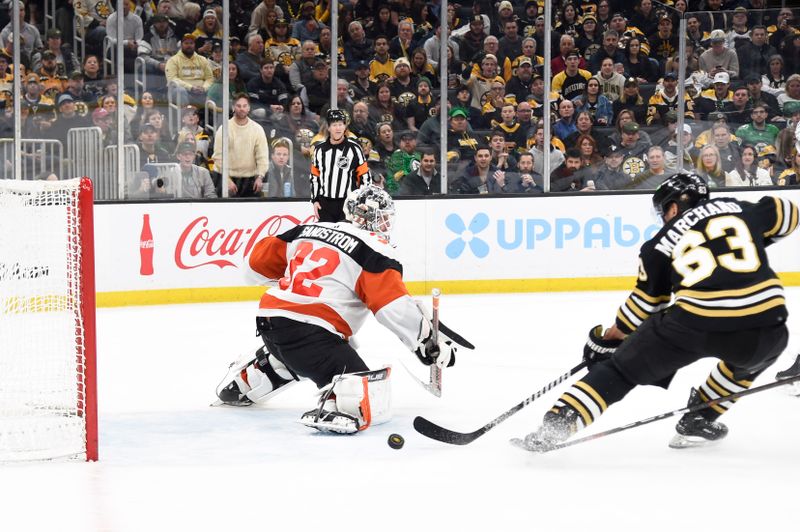 Mar 16, 2024; Boston, Massachusetts, USA; Boston Bruins left wing Brad Marchand (63) tries to redirect the puck past Philadelphia Flyers goaltender Felix Sandstrom (32) during the third period at TD Garden. Mandatory Credit: Bob DeChiara-USA TODAY Sports