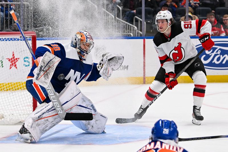 Mar 24, 2024; Elmont, New York, USA;  New York Islanders goaltender Ilya Sorokin (30) makes a save as New Jersey Devils center Dawson Mercer (91) looks for a rebound during the third period at UBS Arena. Mandatory Credit: Dennis Schneidler-USA TODAY Sports