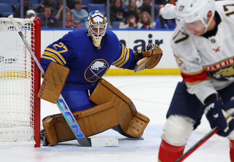 Oct 12, 2024; Buffalo, New York, USA;  Buffalo Sabres goaltender Devon Levi (27) looks for the puck during the third period against the Florida Panthers at KeyBank Center. Mandatory Credit: Timothy T. Ludwig-Imagn Images