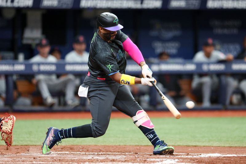 Jul 13, 2024; St. Petersburg, Florida, USA; Tampa Bay Rays first baseman Yandy Diaz (2) hits an rbi double against the Cleveland Guardians in the third inning at Tropicana Field. Mandatory Credit: Nathan Ray Seebeck-USA TODAY Sports