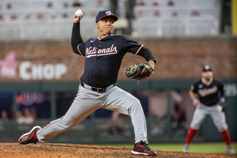 Aug 23, 2024; Cumberland, Georgia, USA; Washington Nationals pitcher Eduardo Salazar (62) pitches against the Atlanta Braves during the eighth inning at Truist Park. Mandatory Credit: Jordan Godfree-USA TODAY Sports