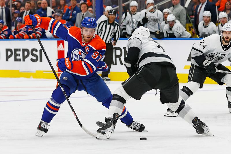 Apr 22, 2024; Edmonton, Alberta, CAN;Edmonton Oilers forward Connor McDavid (97) moves the puck past Los Angeles Kings defensemen Drew Doughty (8) during the third period in game one of the first round of the 2024 Stanley Cup Playoffs at Rogers Place. Mandatory Credit: Perry Nelson-USA TODAY Sports