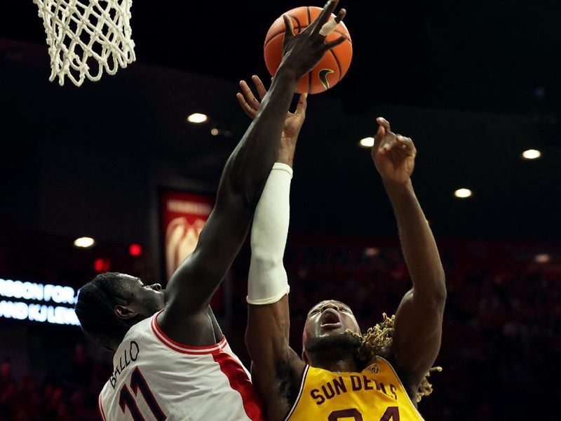 Feb 17, 2024; Tucson, Arizona, USA; Arizona Wildcats center Oumar Ballo (11) blocks a shot against Arizona State Sun Devils forward Bryant Selebangue (24) during the first half at McKale Center. Mandatory Credit: Zachary BonDurant-USA TODAY Sports