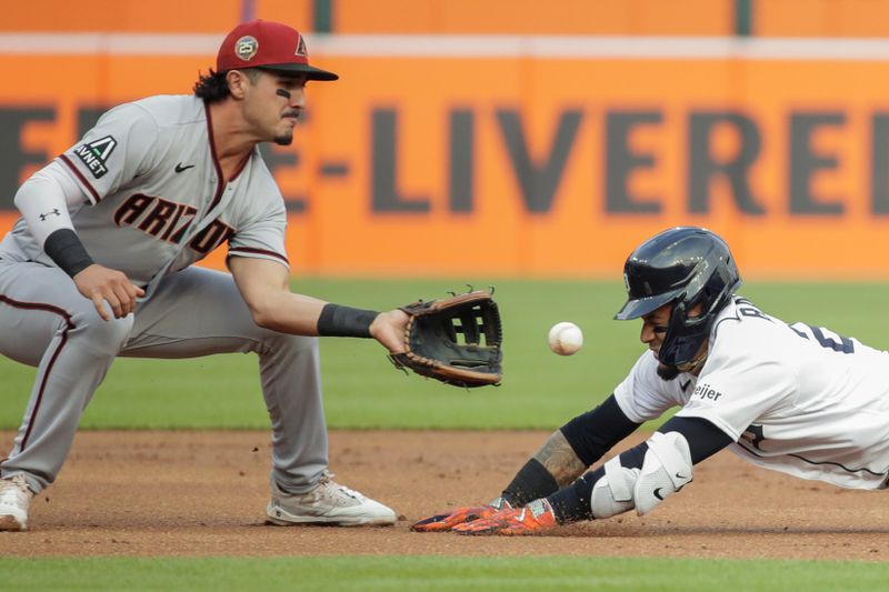 Jun 9, 2023; Detroit, Michigan, USA; Arizona Diamondbacks shortstop Josh Rojas (10) reaches for a throw before tagging out Detroit Tigers Javier B ez (28) at third base during the first inning at Comerica Park. Mandatory Credit: Brian Bradshaw Sevald-USA TODAY Sports