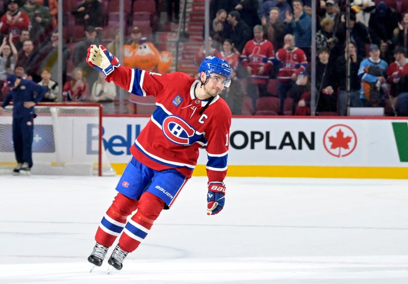 Jan 6, 2025; Montreal, Quebec, CAN; Montreal Canadiens forward Nick Suzuki (14) celebrates the win against the Vancouver Canucks at the Bell Centre. Mandatory Credit: Eric Bolte-Imagn Images