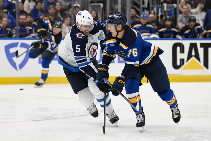 Apr 27, 2025; St. Louis, Missouri, USA; Winnipeg Jets defenseman Luke Schenn (5) defends against St. Louis Blues right wing Zack Bolduc (76) during the second period in game four of the first round of the 2025 Stanley Cup Playoffs at Enterprise Center. Mandatory Credit: Jeff Le-Imagn Images