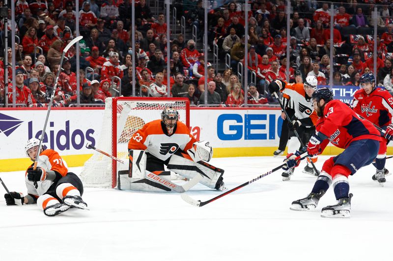 Mar 1, 2024; Washington, District of Columbia, USA; Philadelphia Flyers goaltender Samuel Ersson (33) prepares to make a save on Washington Capitals right wing Tom Wilson (43) in the first period at Capital One Arena. Mandatory Credit: Geoff Burke-USA TODAY Sports