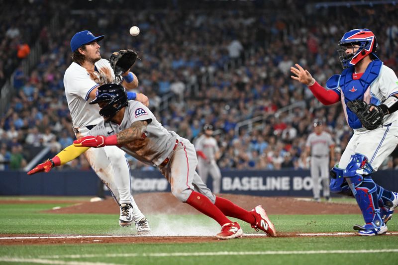 Sep 23, 2025; Toronto, Ontario, CAN;  Toronto Blue Jays third baseman Addison Barger (47) takes a throw from catcher Alejandro Kirk (30) before tagging out Boston Red Sox center fielder Ceddanne Rafaela (3) in a rundown during the sixth inning at Rogers Centre. Mandatory Credit: Dan Hamilton-Imagn Images