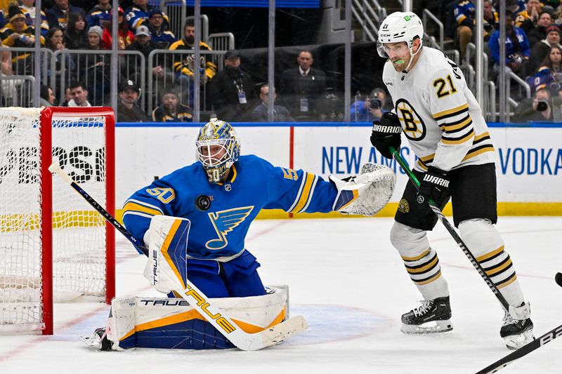 Jan 13, 2024; St. Louis, Missouri, USA;  St. Louis Blues goaltender Jordan Binnington (50) defends the net against Boston Bruins left wing James van Riemsdyk (21) during the third period at Enterprise Center. Mandatory Credit: Jeff Curry-USA TODAY Sports