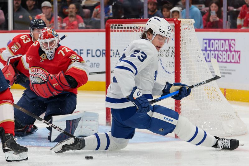Dec 2, 2025; Sunrise, Florida, USA; Toronto Maple Leafs left wing Matthew Knies (23) moves the puck in front of the net of Florida Panthers goaltender Sergei Bobrovsky (72) during the second period at Amerant Bank Arena. Mandatory Credit: Sam Navarro-Imagn Images