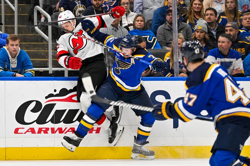 Nov 3, 2023; St. Louis, Missouri, USA;  St. Louis Blues defenseman Justin Faulk (72) checks New Jersey Devils center Curtis Lazar (42) during the third period at Enterprise Center. Mandatory Credit: Jeff Curry-USA TODAY Sports