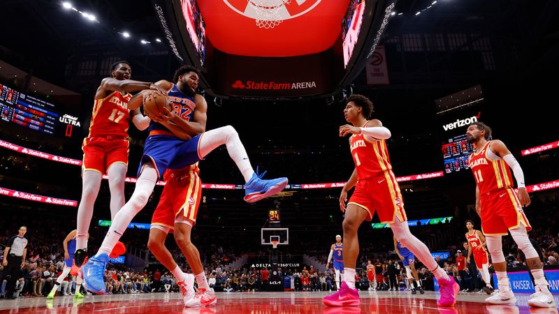 ATLANTA, GEORGIA - NOVEMBER 6: Karl-Anthony Towns #32 of the New York Knicks battles for a rebound against Onyeka Okongwu #17 of the Atlanta Hawks during the first quarter at State Farm Arena on November 6, 2024 in Atlanta, Georgia. NOTE TO USER: User expressly acknowledges and agrees that, by downloading and or using this photograph, User is consenting to the terms and conditions of the Getty Images License Agreement. (Photo by Todd Kirkland/Getty Images)