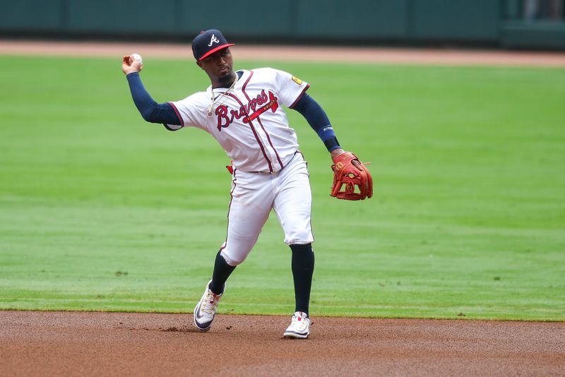 Sep 30, 2024; Atlanta, Georgia, USA; Atlanta Braves second baseman Ozzie Albies (1) throws a runner out at first against the New York Mets in the first inning at Truist Park. Mandatory Credit: Brett Davis-Imagn Images